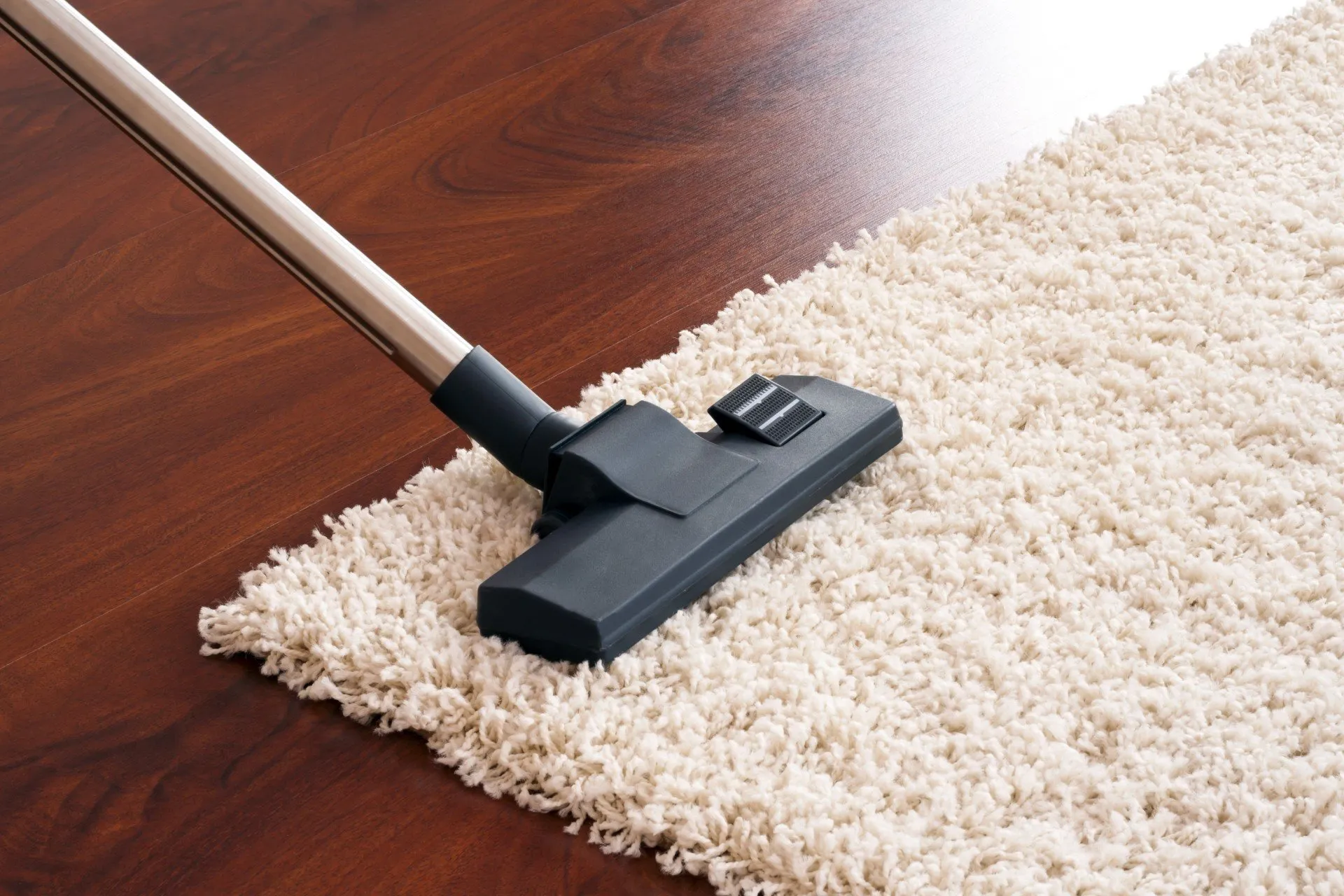 close shot of vacuum cleaner on a white rug